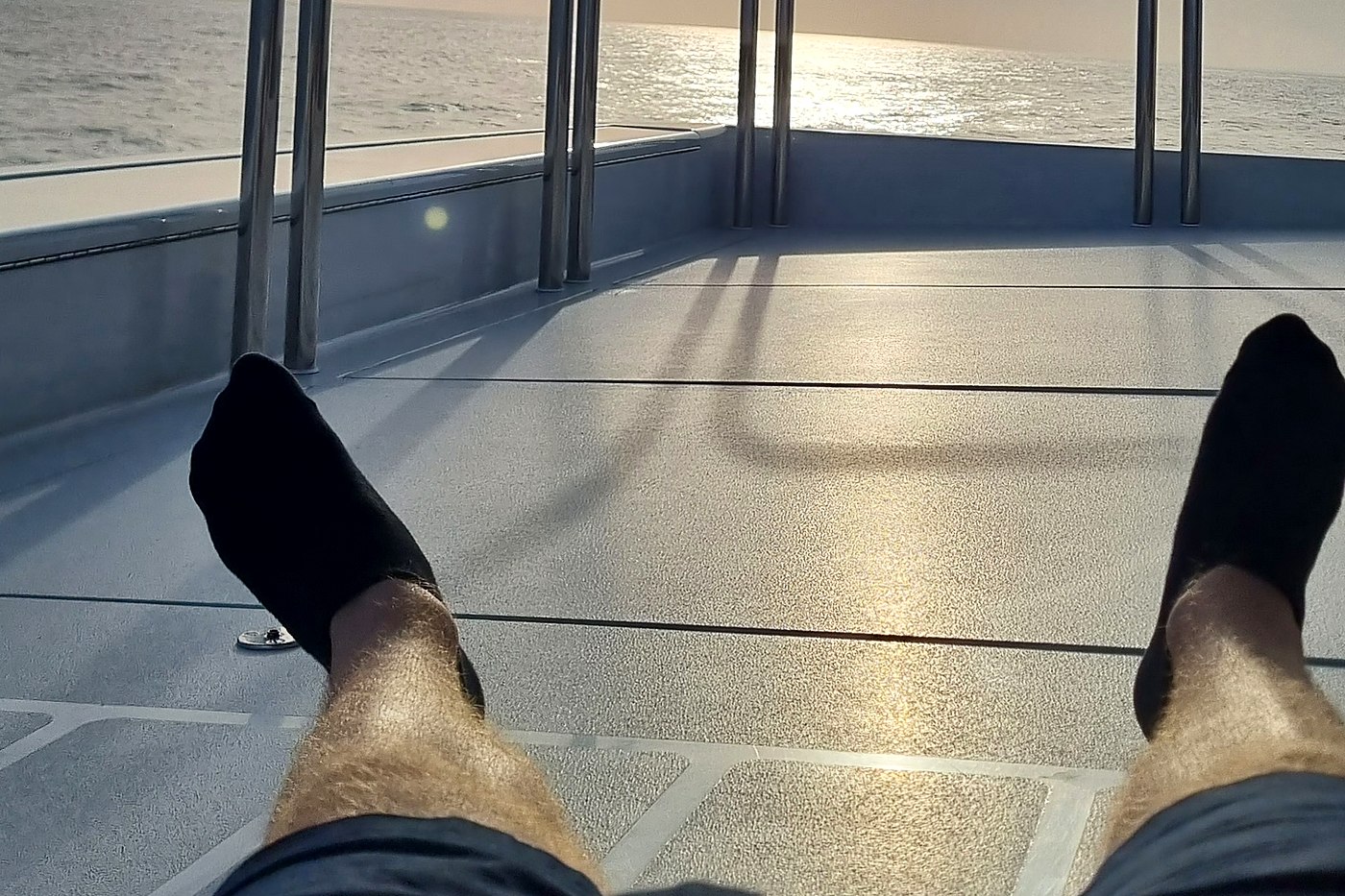 Feet up on deck at sunset after a day’s work