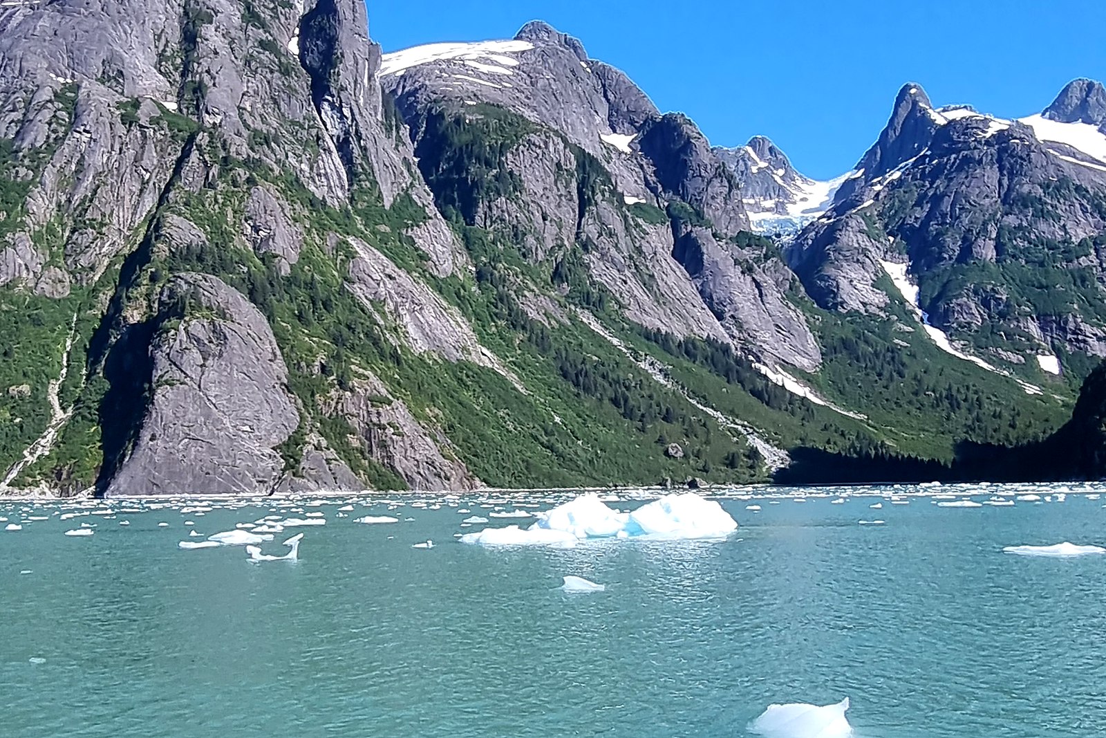 Snow-capped fjord mountains seen from a superyacht’s deck