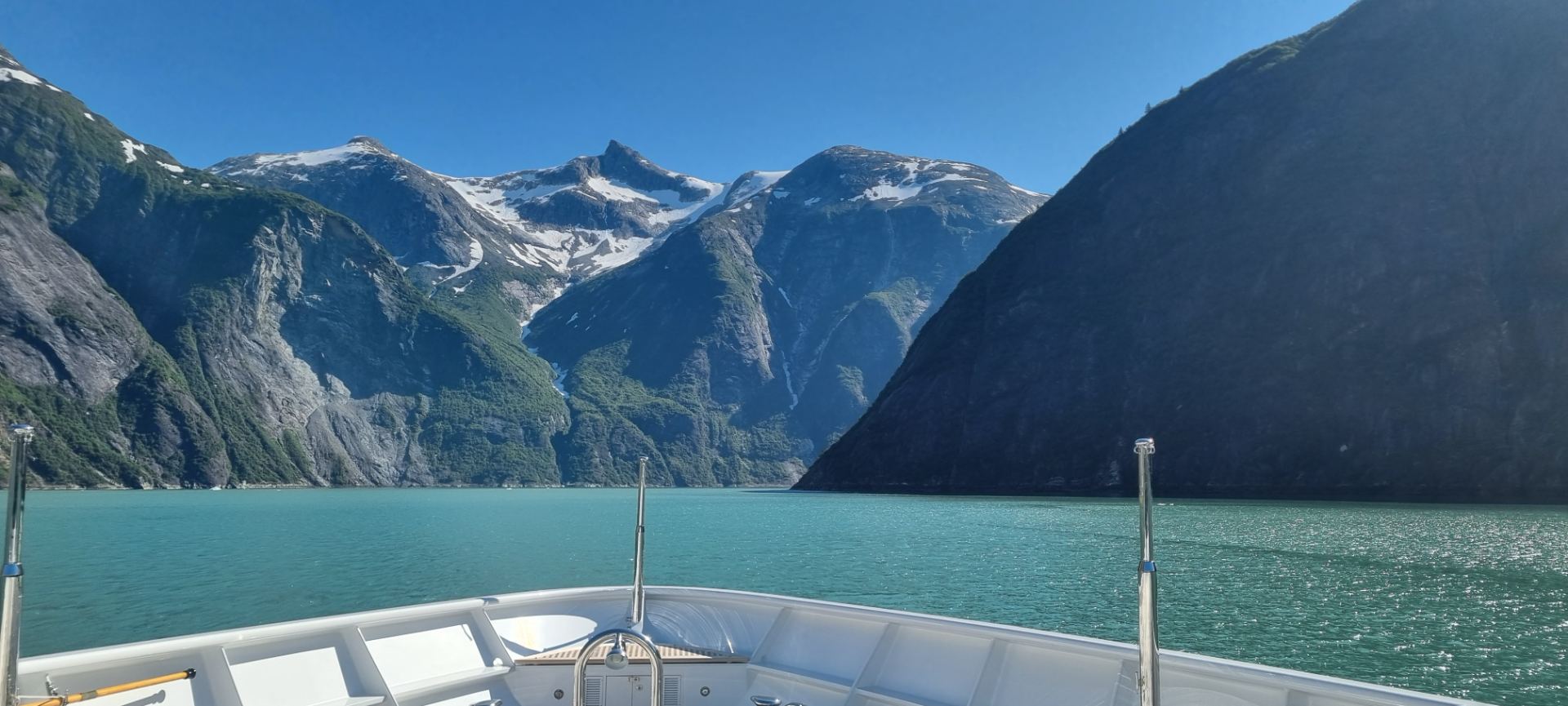 Crew on a superyacht tender in a remote fjord
